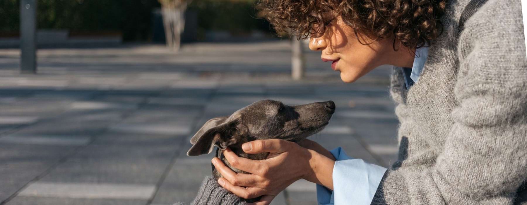 a woman holding a dog